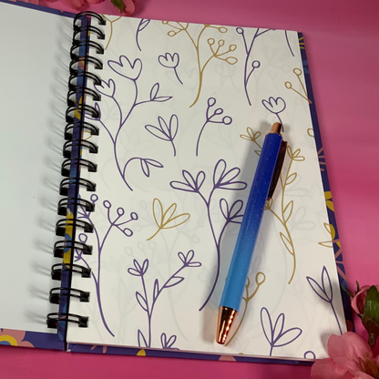 Open notebook with floral pattern on pink background