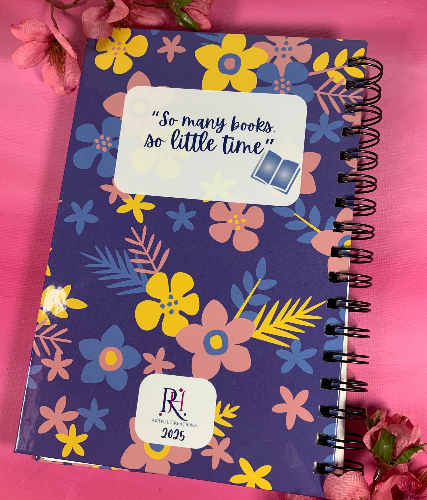 Floral notebook with a quote on a pink background