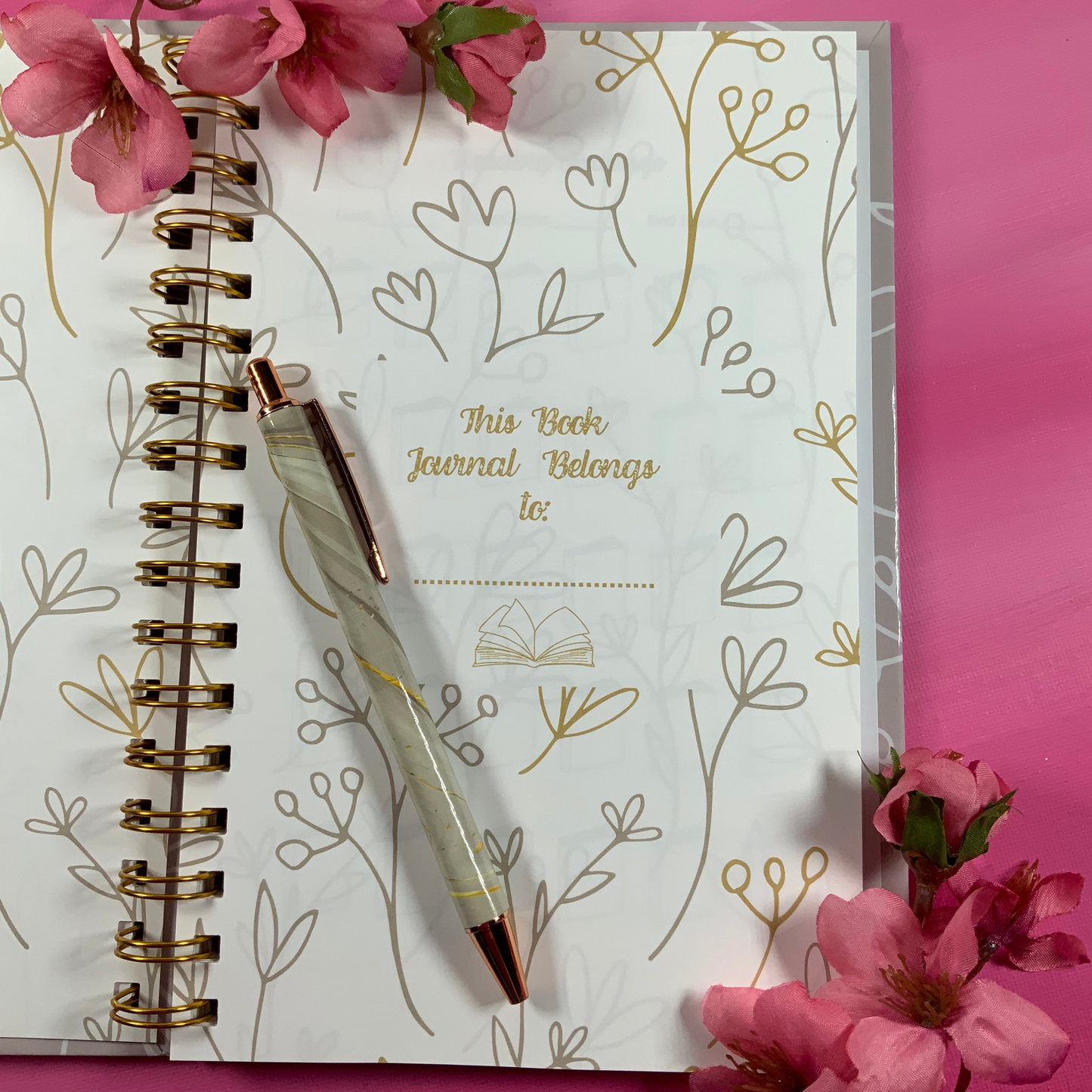 Journal with floral design on pink background