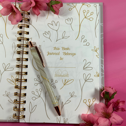 Journal with floral design on pink background