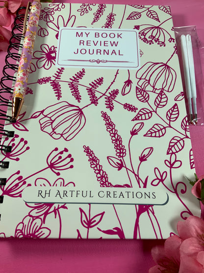Book review journal with floral design and 'RH Artful Creations' branding on a pink background.