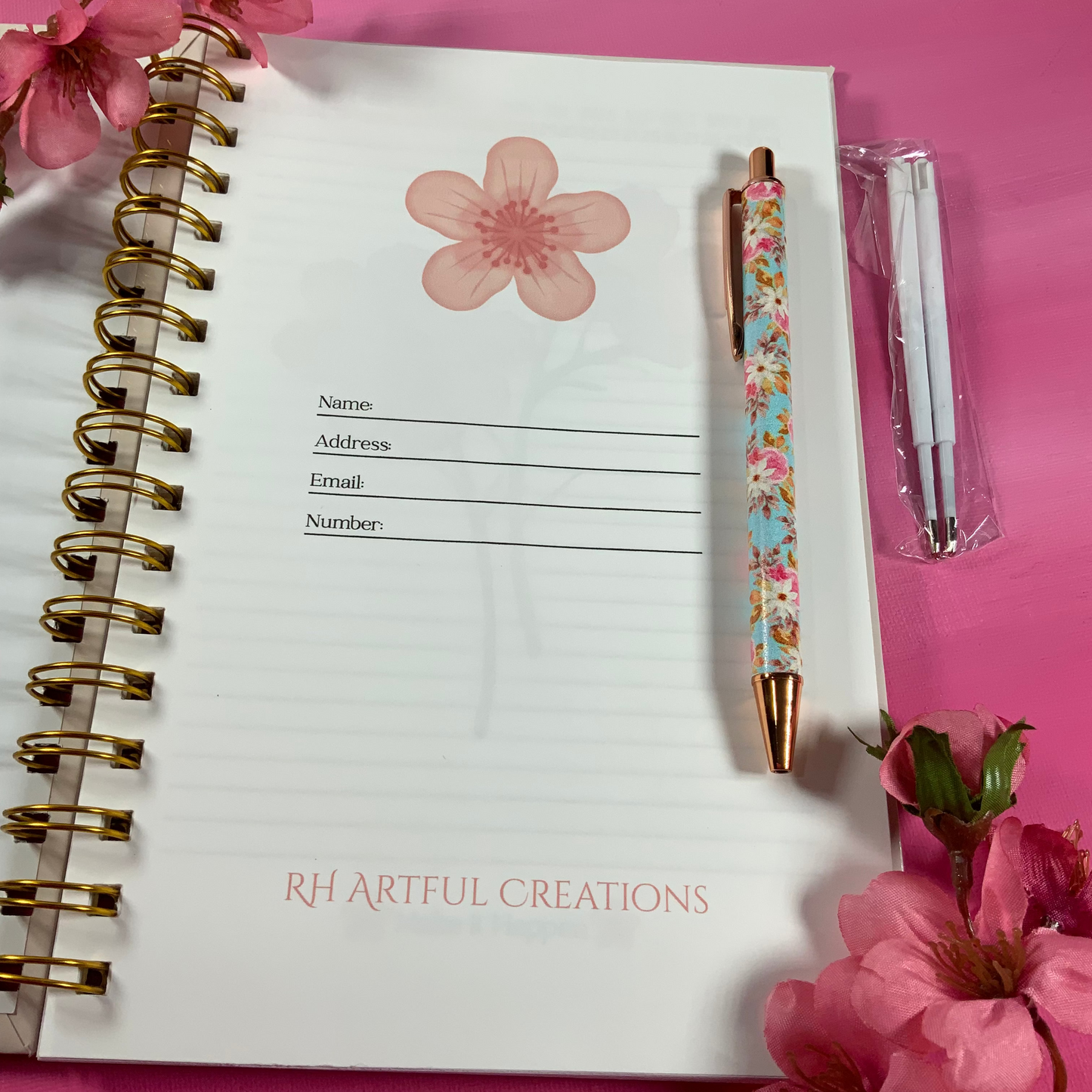 Notebook with floral design on pink background
