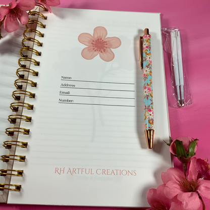 Notebook with floral design on pink background