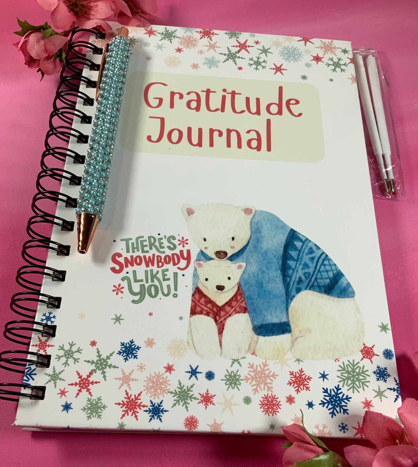 Gratitude journal with a polar bear illustration on a pink background