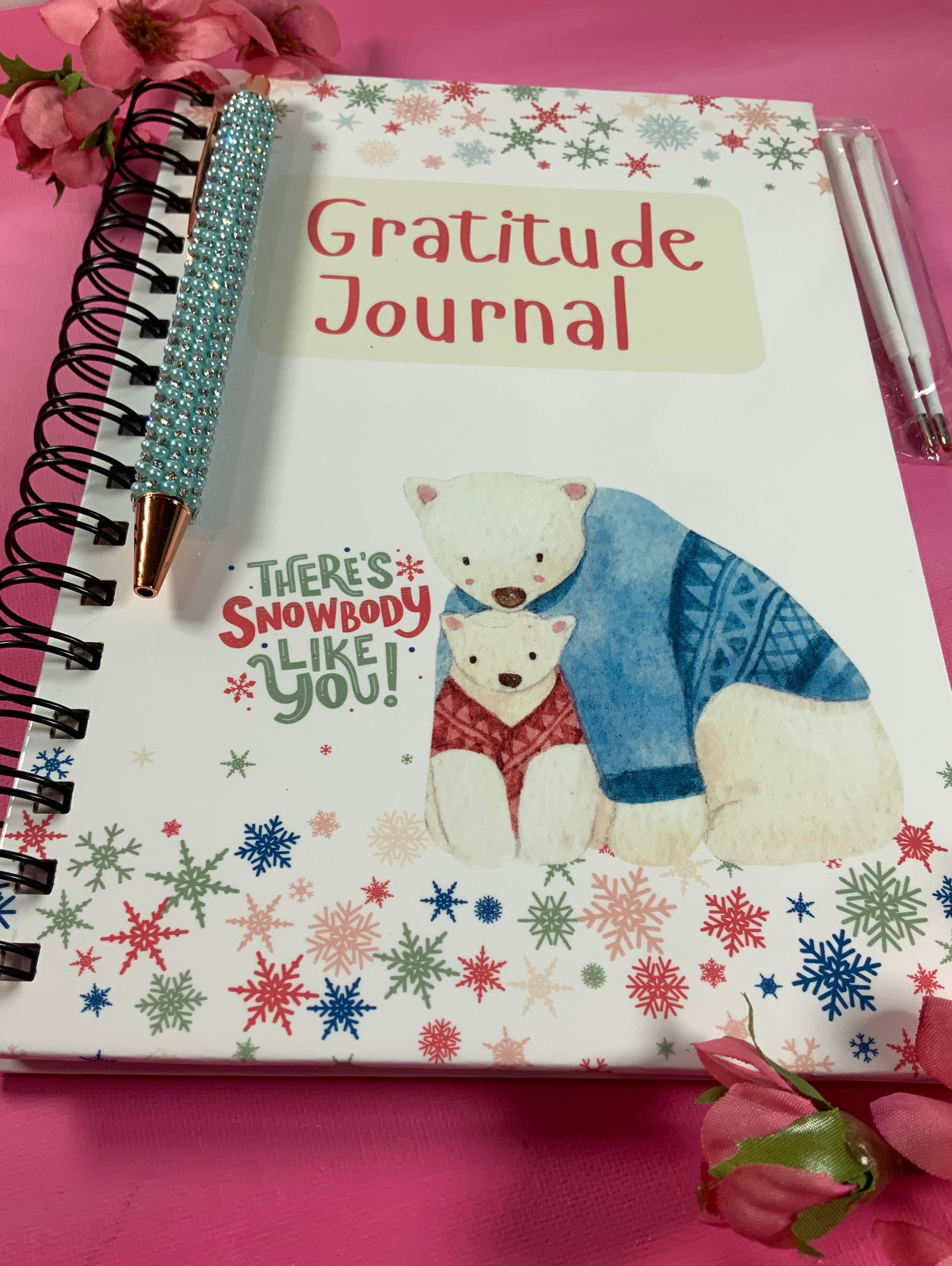 Gratitude journal with a polar bear illustration on a pink background