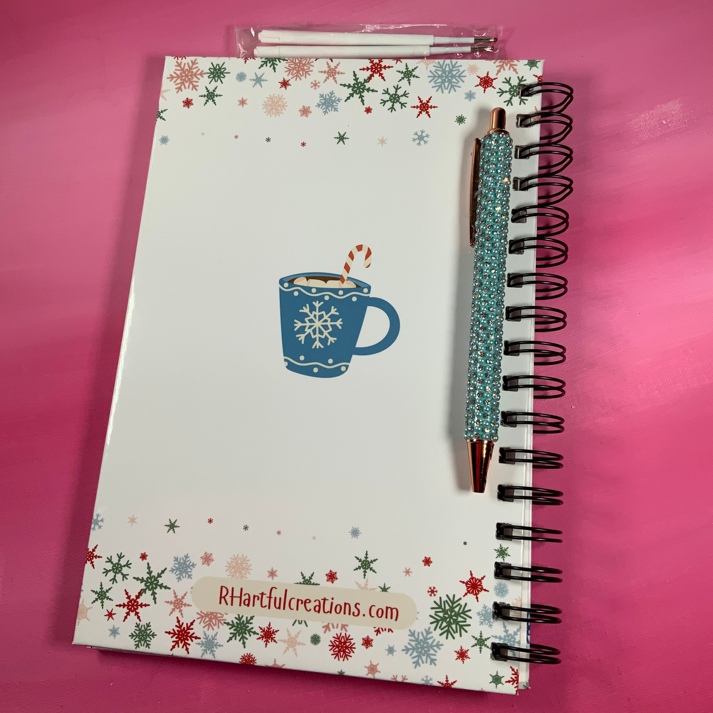 Notebook with a festive design on a pink background