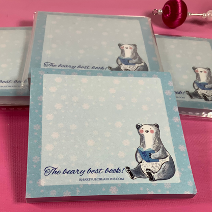 Notebook with bear illustration and text on a pink surface