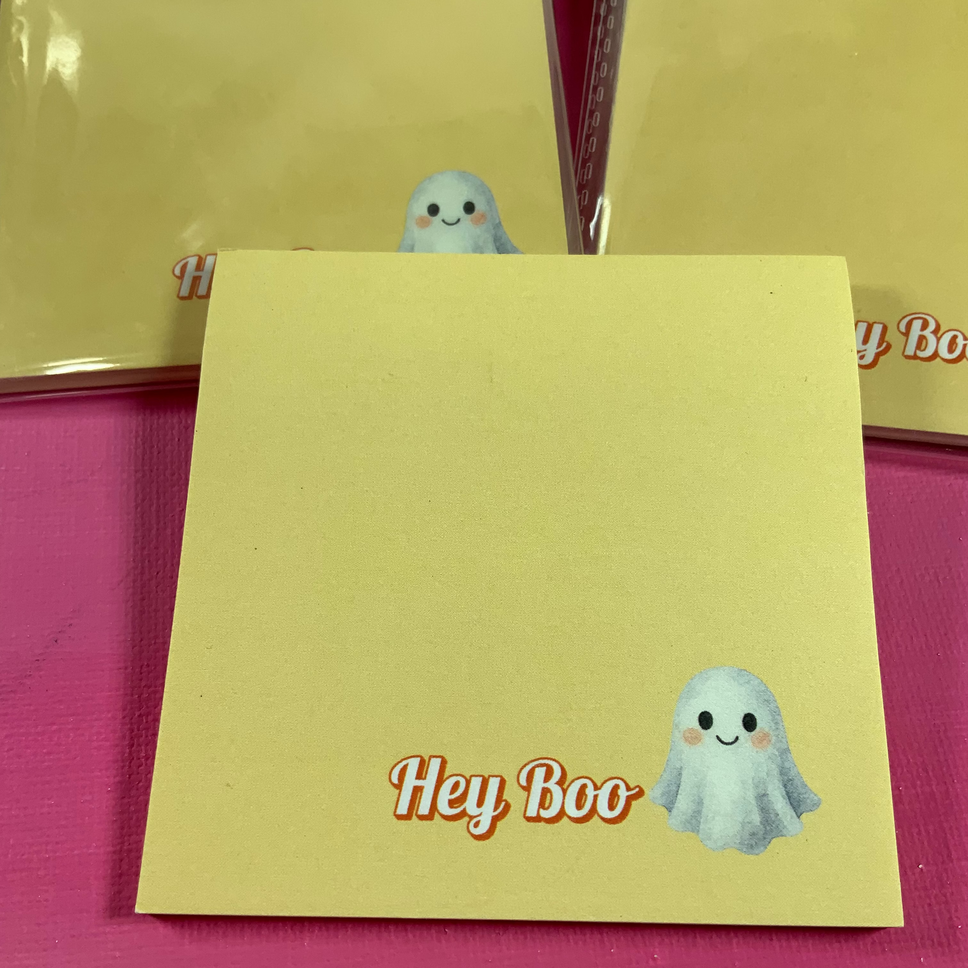 Yellow card with 'Hey Boo' text and ghost illustration on a pink background