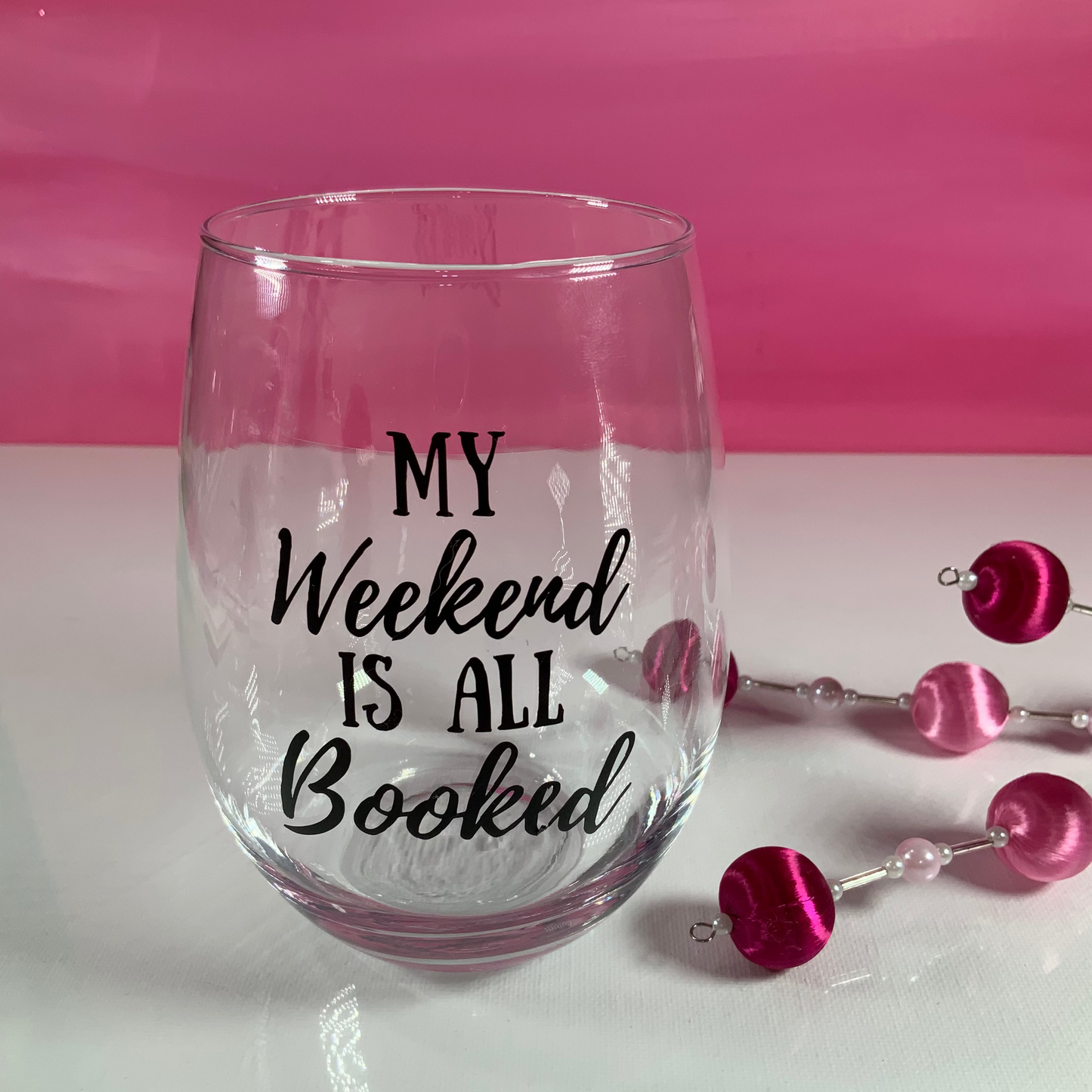 Clear glass with 'My Weekend is All Booked' text on a pink background