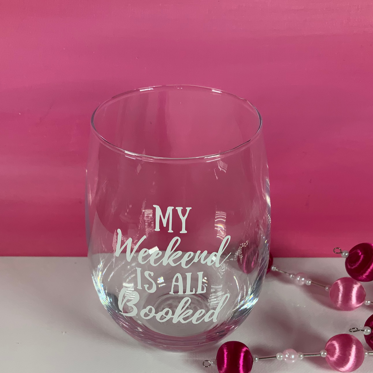 Clear glass with 'My Weekend is All Booked' text on a pink and white background
