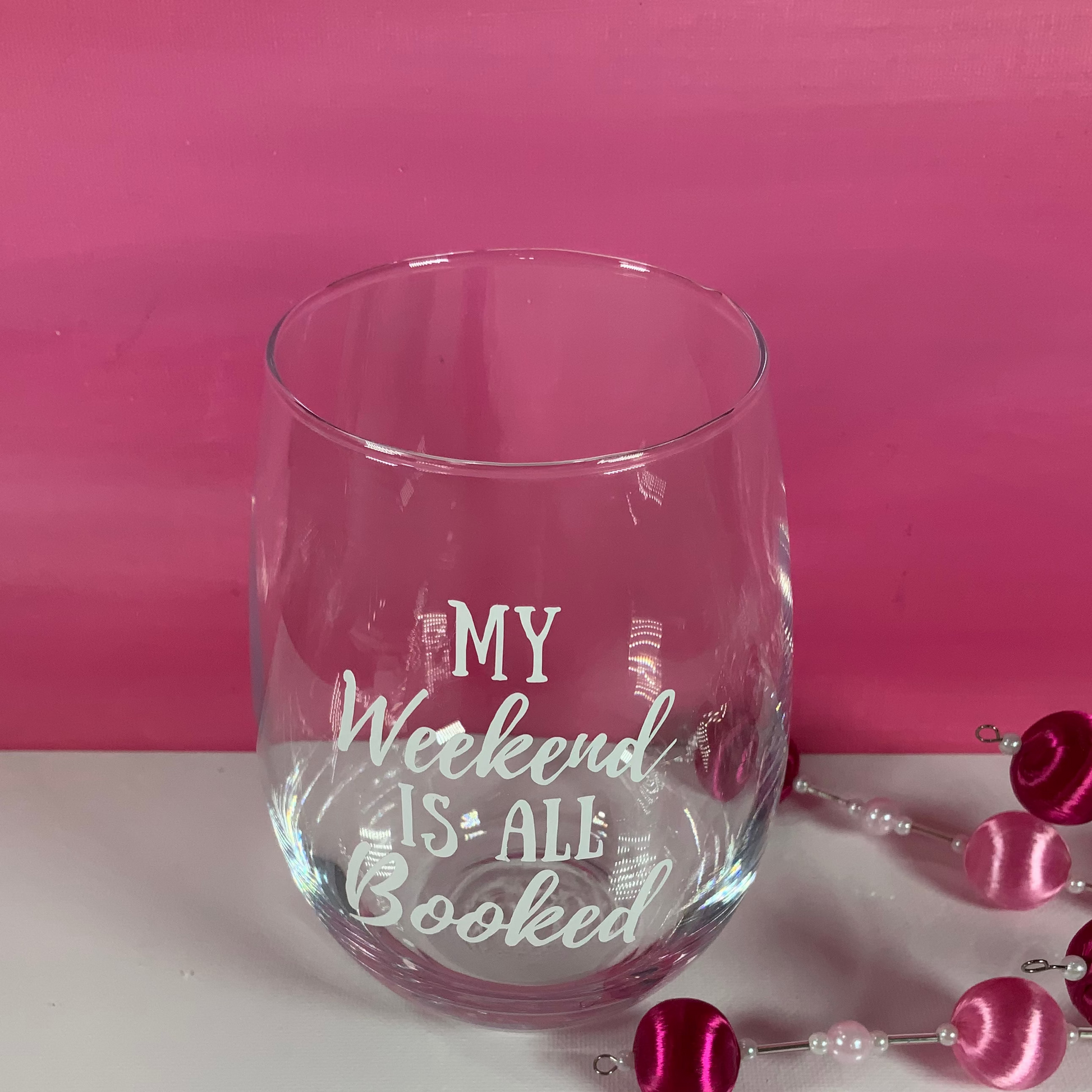 Clear glass with 'My Weekend is All Booked' text on a pink and white background