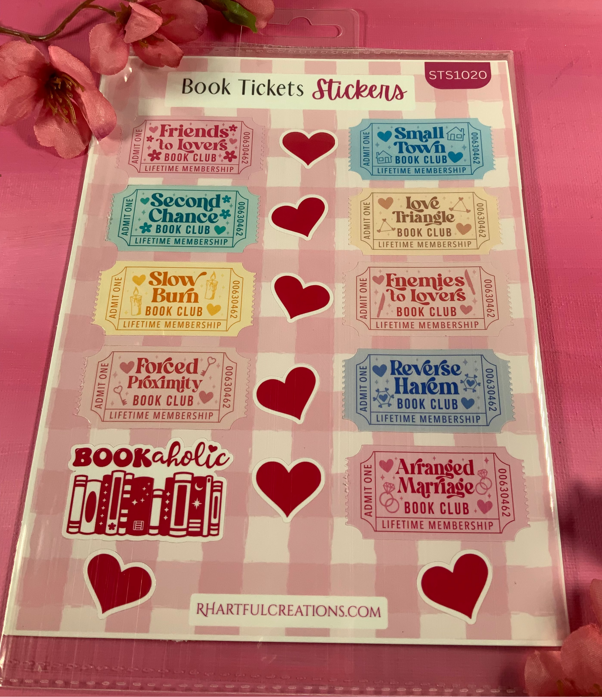 Sheet of book-themed stickers with hearts on a pink background