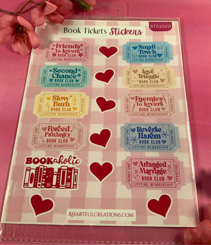 Sheet of book-themed stickers with hearts on a pink background