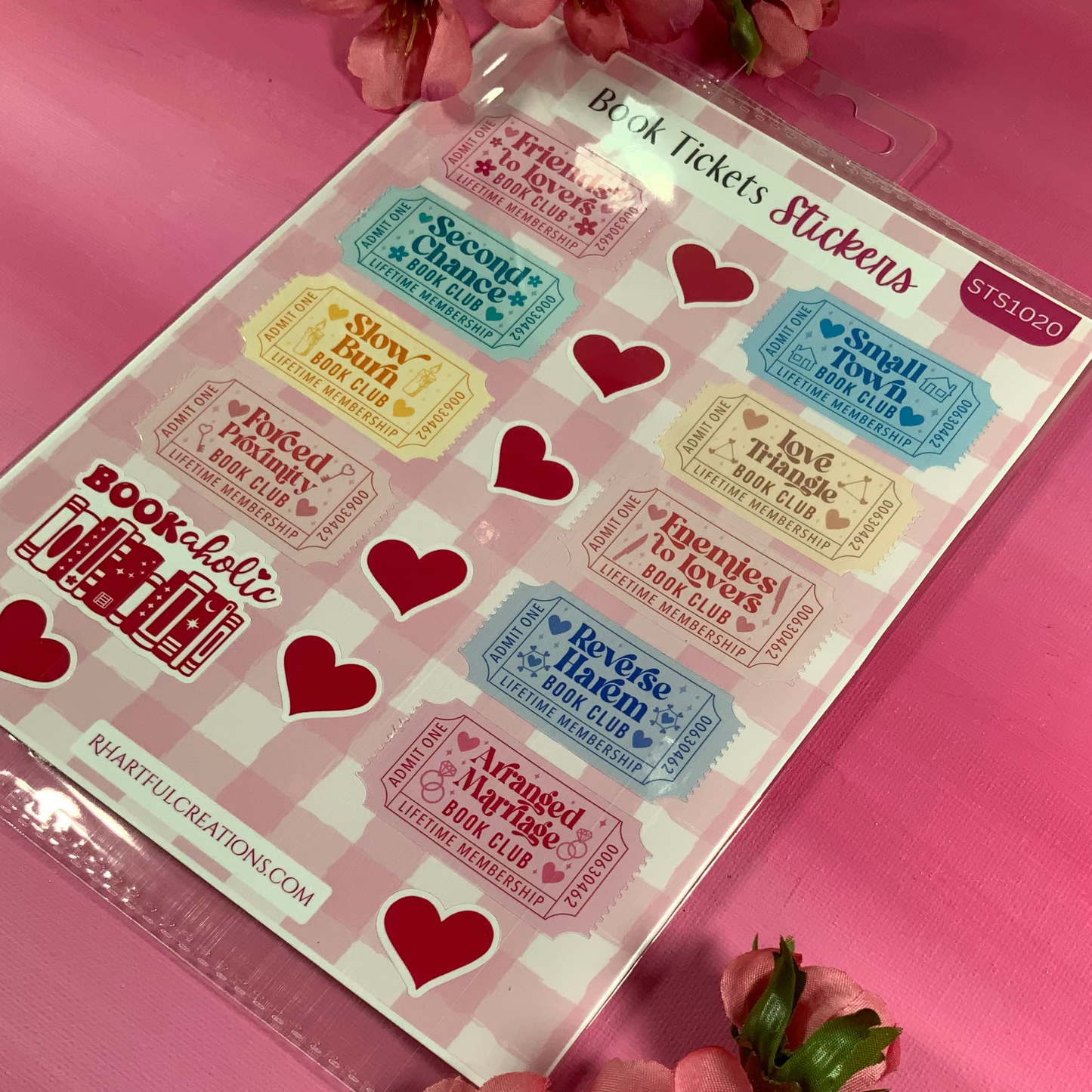 Sheet of book ticket stickers with decorative flowers on a pink background