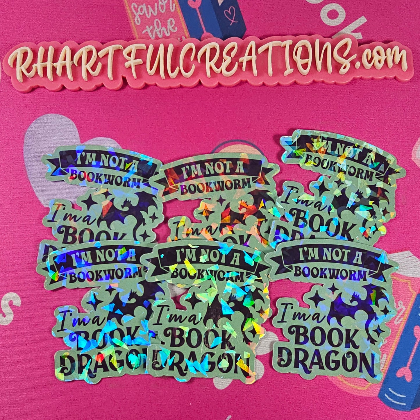 “I’m Not a Bookworm, I’m a Book Dragon” holographic vinyl sticker with rainbow sparkle finish, handmade by RH Artful Creations.