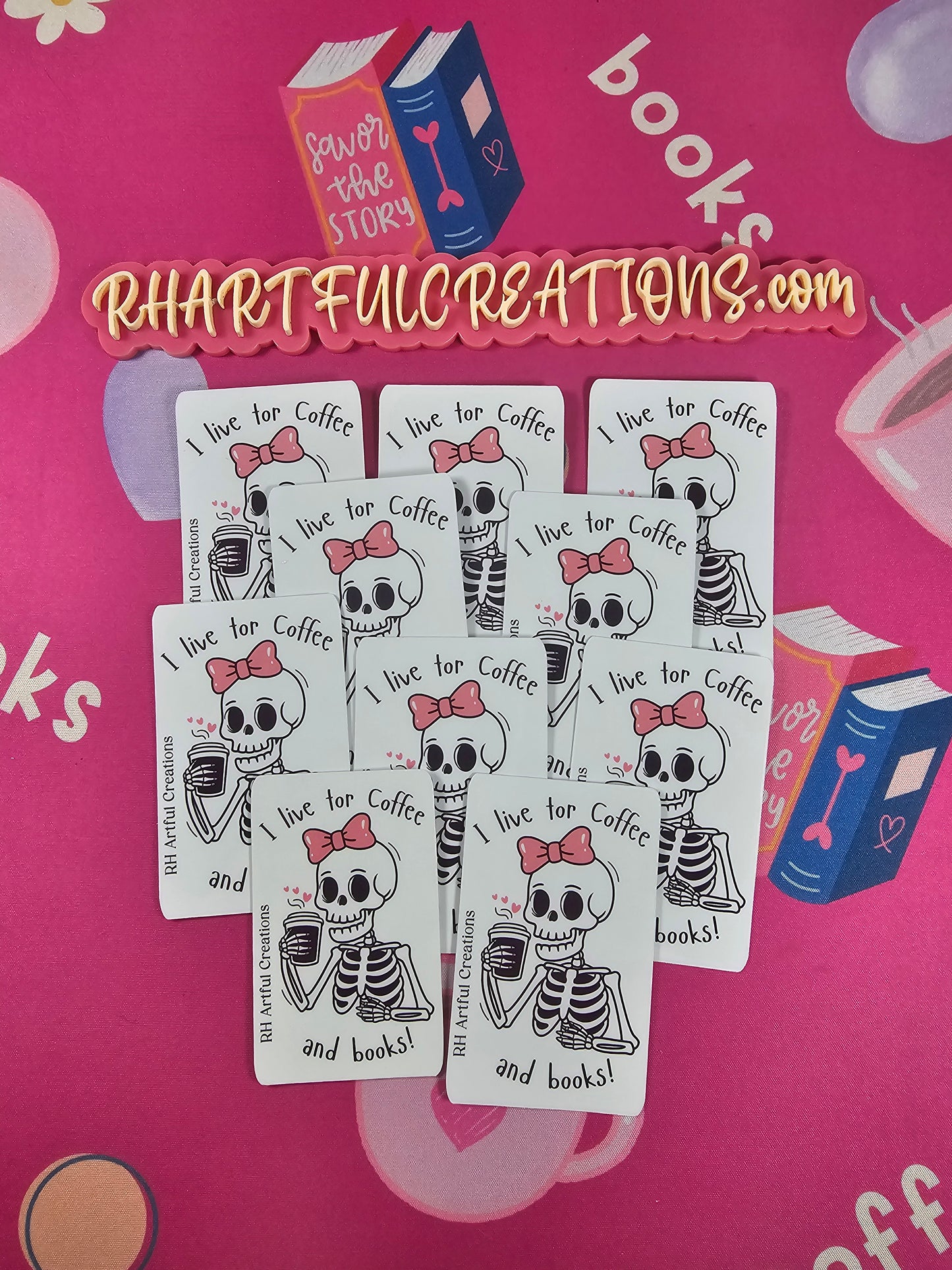 Sticker featuring a cute skeleton with a pink bow holding coffee and the quote “I live for coffee and books!” Handmade by RH Artful Creations on a pink book-themed background.