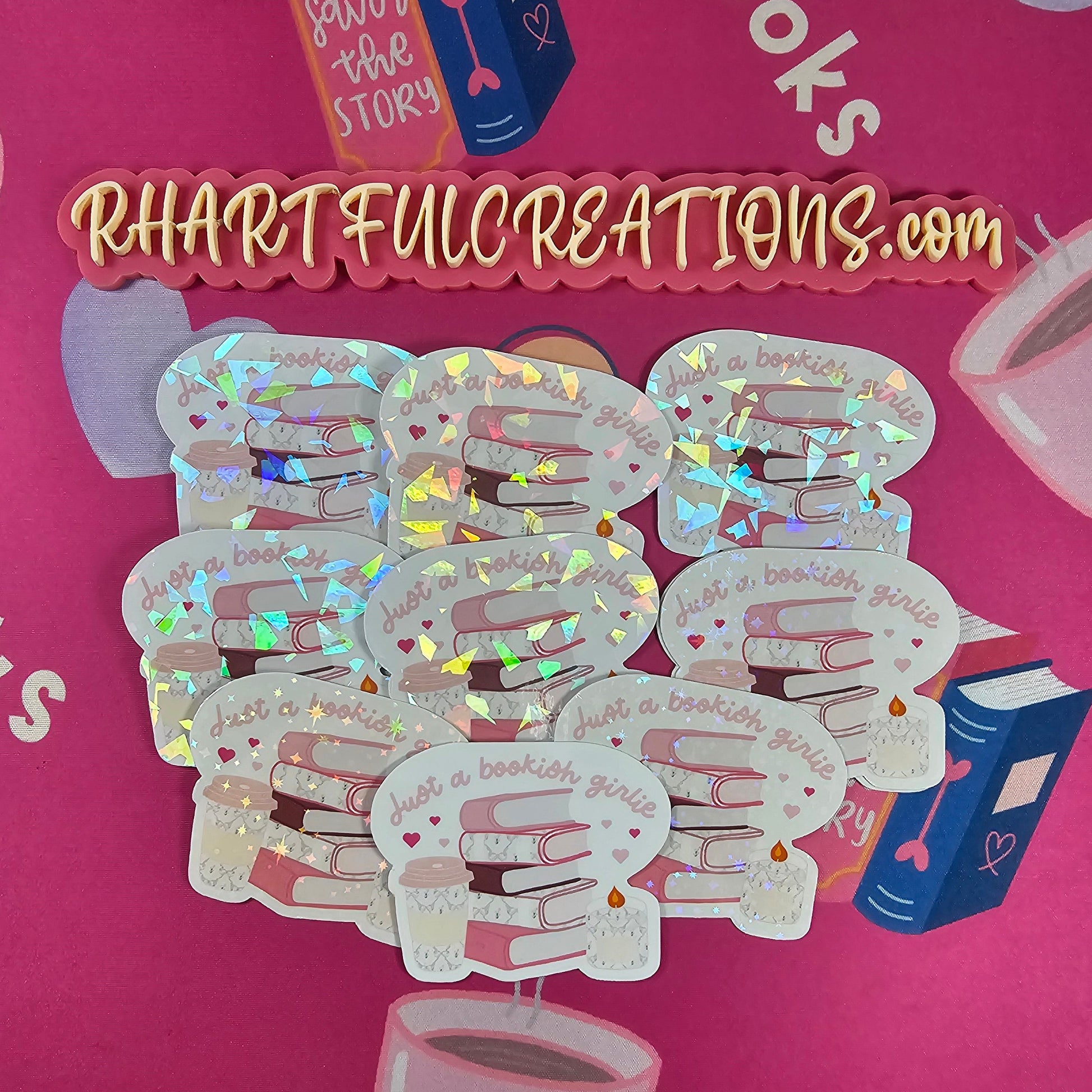 “Just a Bookish Girlie” sticker with pink stacked books, coffee cup, and candle — handmade by RH Artful Creations for book lovers.