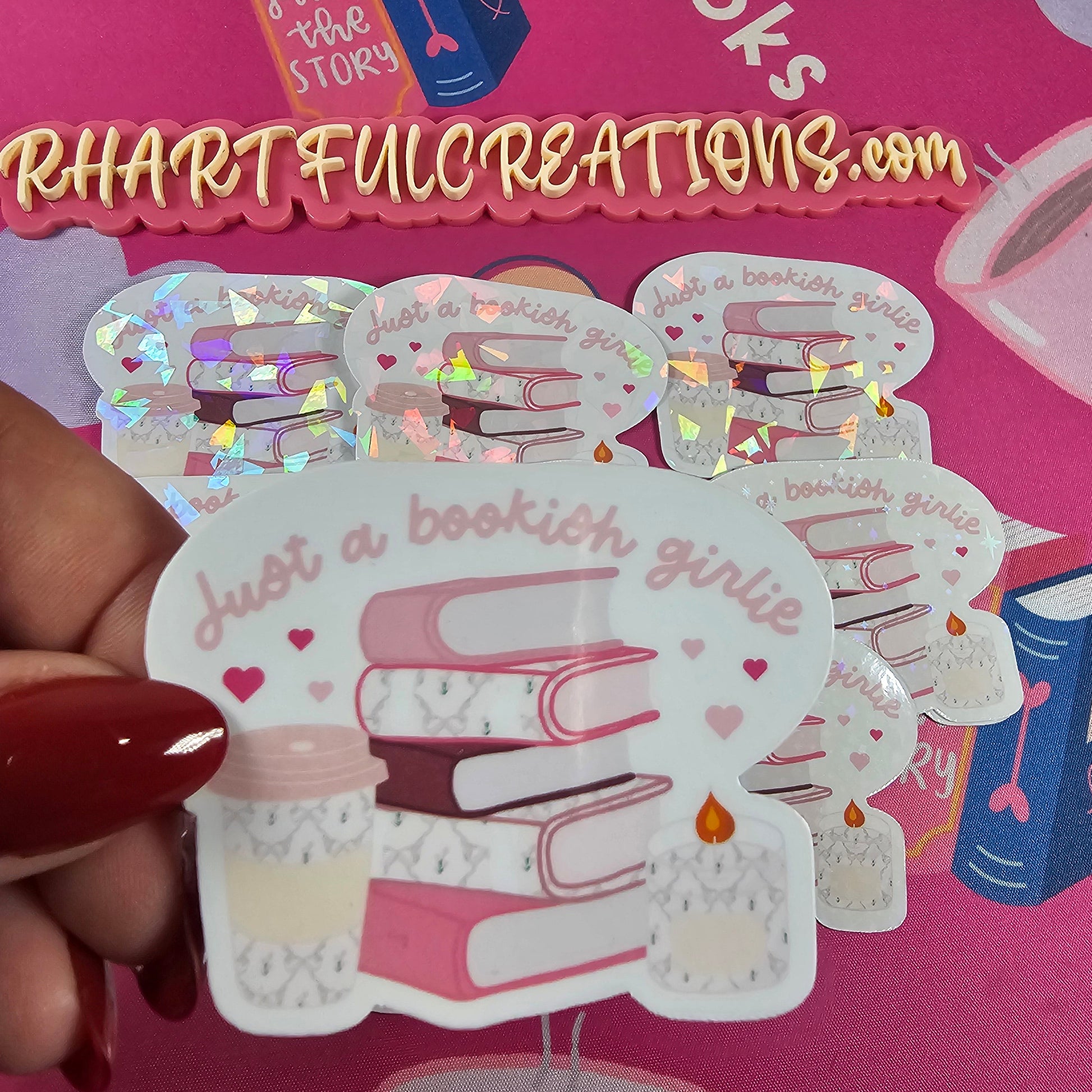 “Just a Bookish Girlie” sticker with pink stacked books, coffee cup, and candle — handmade by RH Artful Creations for book lovers.