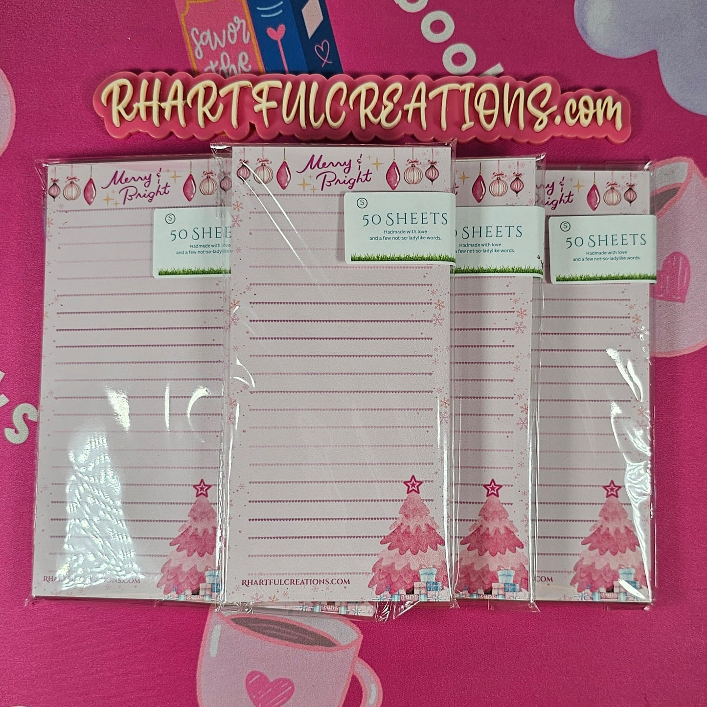 Set of Christmas-themed notepads with 'RHARTFULCREATIONS.com' branding on a pink background.