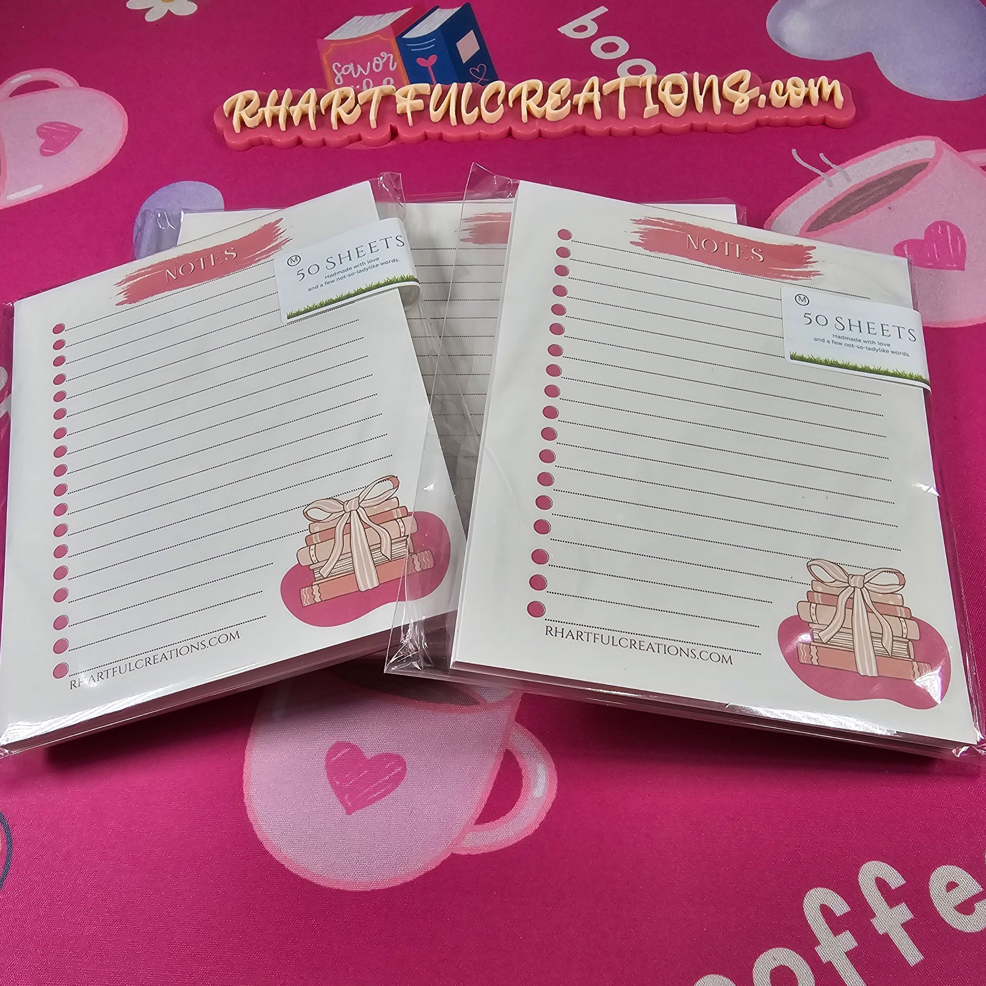 Note pads with decorative designs on a pink background with 'RHAT FUL CREATIONS' branding.